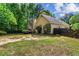 Lush backyard featuring the home's exterior, landscaping, and a privacy fence at 1694 Peachcrest Ct, Lawrenceville, GA 30043