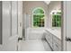 Elegant bathroom with a garden tub, large window, and double vanity at 1694 Peachcrest Ct, Lawrenceville, GA 30043