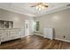 Bright bedroom with wood floors, white dressers, and natural light from the window at 1694 Peachcrest Ct, Lawrenceville, GA 30043