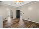Bedroom featuring beautiful floors and an arched doorway leading to a sunny room at 1694 Peachcrest Ct, Lawrenceville, GA 30043