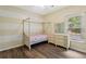 Bedroom featuring four-poster bed, dresser, and window at 1694 Peachcrest Ct, Lawrenceville, GA 30043