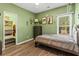 Green bedroom with closet, showcasing a bed, natural light, and tasteful decor for a relaxing atmosphere at 1694 Peachcrest Ct, Lawrenceville, GA 30043