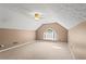 Large bonus room offering versatile space with vaulted ceilings, carpet, and natural light at 1694 Peachcrest Ct, Lawrenceville, GA 30043