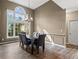 Elegant dining room with large windows and stylish chandelier, perfect for gatherings at 1694 Peachcrest Ct, Lawrenceville, GA 30043