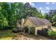 Aerial view highlighting the home's backyard, deck, and surrounding mature trees at 1694 Peachcrest Ct, Lawrenceville, GA 30043