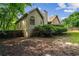 Exterior view of the home with backyard, a fence and mature trees offering privacy at 1694 Peachcrest Ct, Lawrenceville, GA 30043