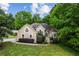 A charming home featuring a well-manicured lawn, mature landscaping, and a traditional style exterior at 1694 Peachcrest Ct, Lawrenceville, GA 30043