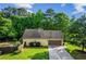 Front exterior view of home with a two-car garage, driveway, and well-maintained landscaping at 1694 Peachcrest Ct, Lawrenceville, GA 30043