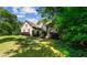 Beautiful home exterior with lush landscaping, offering great curb appeal at 1694 Peachcrest Ct, Lawrenceville, GA 30043