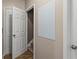 Hallway view highlighting a practical whiteboard and access to stairs and storage at 1694 Peachcrest Ct, Lawrenceville, GA 30043
