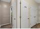 Functional hallway showcasing wood-look floors and multiple closet doors, providing ample storage space at 1694 Peachcrest Ct, Lawrenceville, GA 30043