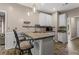 Open kitchen featuring granite countertops, barstool seating and wood-look floors at 1694 Peachcrest Ct, Lawrenceville, GA 30043