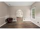 Inviting living room featuring an arched doorway and hardwood flooring at 1694 Peachcrest Ct, Lawrenceville, GA 30043