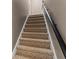 Carpeted stairway showcasing a modern handrail, providing safe and comfortable access to upper levels at 1694 Peachcrest Ct, Lawrenceville, GA 30043