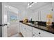 Stylish bathroom with sleek vanity, granite countertop, and an open view to the bedroom and the green yard at 4814 Sultana Sw Way, Atlanta, GA 30331