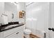Bathroom featuring black countertop, white cabinets, and shower with curtain at 4814 Sultana Sw Way, Atlanta, GA 30331