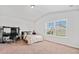 Bright bedroom featuring a bed, study area with desk, and large window for natural light at 4814 Sultana Sw Way, Atlanta, GA 30331