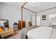 Comfortable bedroom featuring a four-poster bed, neutral walls, and access to a walk-in closet at 4814 Sultana Sw Way, Atlanta, GA 30331