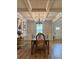 Formal dining room with a coffered ceiling, hardwood floors, and modern lighting at 4814 Sultana Sw Way, Atlanta, GA 30331