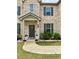 Inviting front entrance with a landscaped yard, stone border, and dark front door at 4814 Sultana Sw Way, Atlanta, GA 30331
