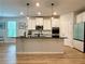 Stunning kitchen features white cabinetry, an island with pendant lights, and stainless steel appliances at 4814 Sultana Sw Way, Atlanta, GA 30331