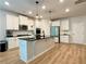 This stylish kitchen features white cabinets, black countertops, and modern lighting fixtures at 4814 Sultana Sw Way, Atlanta, GA 30331