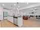 Open kitchen flows into the living room, featuring stainless steel appliances and a modern island with seating at 4814 Sultana Sw Way, Atlanta, GA 30331
