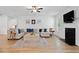 Inviting living room featuring a fireplace, ceiling fan, light walls, and luxury vinyl plank flooring at 4814 Sultana Sw Way, Atlanta, GA 30331