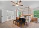 Gorgeous main bedroom includes a four-poster bed, ensuite bathroom, and windows overlooking the green yard at 4814 Sultana Sw Way, Atlanta, GA 30331