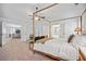 Light-filled main bedroom boasts a four-poster bed and an open view to the living area and bathroom at 4814 Sultana Sw Way, Atlanta, GA 30331