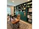 Home office with custom green built-in bookshelves and a rustic wooden desk at 4814 Sultana Sw Way, Atlanta, GA 30331