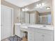 Bathroom featuring a double vanity with bright white cabinets and a large mirror at 4845 Backbay St, Suwanee, GA 30024