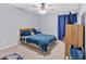 Comfortable bedroom featuring a ceiling fan, carpeted floor, and bright, neutral paint at 4845 Backbay St, Suwanee, GA 30024