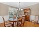 Bright dining room featuring hardwood floors, wainscoting, and ample natural light at 4845 Backbay St, Suwanee, GA 30024