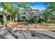 Beautiful two-story home boasts a stone facade, a covered porch, and mature trees at 4845 Backbay St, Suwanee, GA 30024