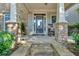 Inviting front porch with stone columns and a cozy seating area at 4845 Backbay St, Suwanee, GA 30024