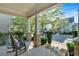 Charming front porch with stone columns, a rocking chair, and well-maintained landscaping at 4845 Backbay St, Suwanee, GA 30024