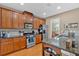 Well-lit kitchen with stainless steel appliances, rich wood cabinetry, and modern fixtures at 4845 Backbay St, Suwanee, GA 30024