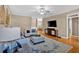Cozy living room featuring hardwood floors, a ceiling fan, and a flatscreen television at 4845 Backbay St, Suwanee, GA 30024