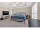 Large main bedroom with tray ceiling, natural light, and calming neutral paint at 4845 Backbay St, Suwanee, GA 30024