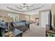Spacious main bedroom with tray ceiling, sitting area, and a treadmill at 4845 Backbay St, Suwanee, GA 30024