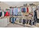 Spacious walk-in closet with extensive shelving and ample storage space for clothes at 4845 Backbay St, Suwanee, GA 30024