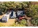 Aerial view of house surrounded by lush trees, backyard, and an outbuilding at 965 Sundew Se Dr, Conyers, GA 30013