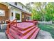 Multi-level back porch of brick home with many steps and trees on a sunny day at 965 Sundew Se Dr, Conyers, GA 30013