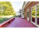 View of the back porch with outside bench, brick house and green grass at 965 Sundew Se Dr, Conyers, GA 30013