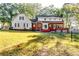 View of backyard of the property surrounded by many trees and a fence at 965 Sundew Se Dr, Conyers, GA 30013