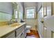 Cozy bathroom features a vanity, framed mirror, window and bead board walls at 965 Sundew Se Dr, Conyers, GA 30013