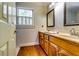 Bathroom featuring double vanity, window, and neutral color palette at 965 Sundew Se Dr, Conyers, GA 30013