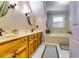 Bright bathroom featuring double vanity, soaking tub and tile flooring at 965 Sundew Se Dr, Conyers, GA 30013