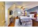 Spacious bedroom with TV, ceiling fan, hardwood floors, and ample natural light at 965 Sundew Se Dr, Conyers, GA 30013